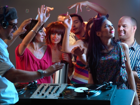 sexy, young women dancing and flirting with the dj in a night clubの写真素材