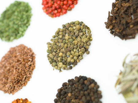 round spices on white background macro close-up detail colorful