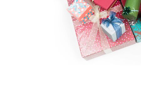 closeup of a pile of colorful gift boxes with beautiful decorations, framed in the right corner of the image, isolated on white backgroundの写真素材