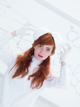 general-view of a pretty face girl student in a chemistry lab playing with lab tools and a  white-board on the backgroundの写真素材