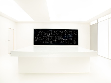 general-view  of a chemistry laboratory with a worktable and blackboard with formulas on it on the backgroundの写真素材