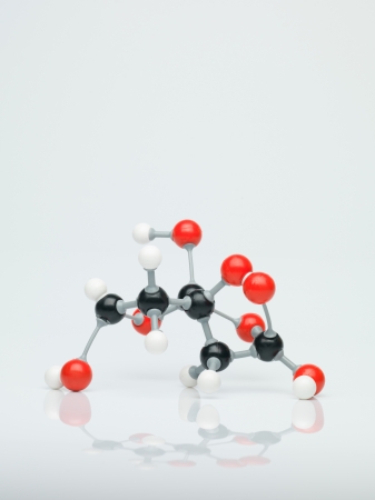 three dimensional representation molecular structure composed of red, white and black spheres with grey bonds against a white backgroundの写真素材