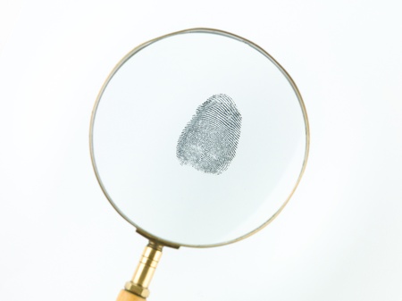 top view of a fingerprint viewed through a magnifying glass, against a white backgroundの写真素材