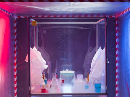 different glass containers filled with differently colored liquids in a sterile chamber filled with reaction vaporsの写真素材