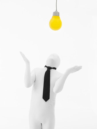 faceless man dressed in white with black tie with yellow bulb on top of his head, isolated の写真素材