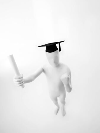 Unknown person dressed in black tie and white suit with graduate hat and diploma, top viewの写真素材