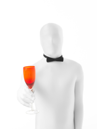 man with bow tie holding a colored glassの写真素材