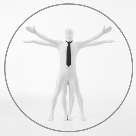 faceless man dressed in white with black tie imitates the work of DaVinci vitruvian man の写真素材