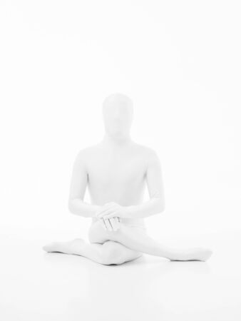 faceless man dressed in white yoga gomukhasana postureの写真素材