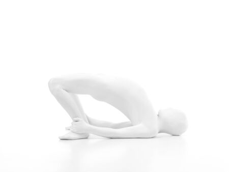 faceless man dressed in white sitting in yoga positionの写真素材
