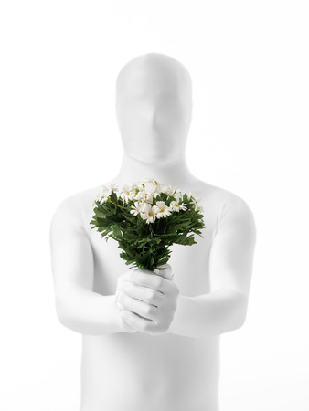 faceless man dressed  white with a bouquet of flowers in handの写真素材