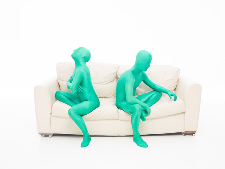 two green couple faceless people sitting on the couch, upset with each other の写真素材