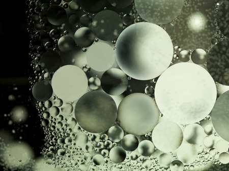 oil drops on water surface with black and white backgroundの写真素材