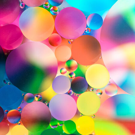 experiment with oil drops on water, colorful backgroundの写真素材