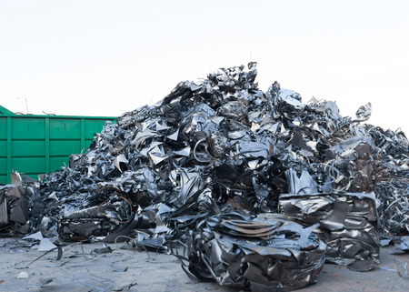 pile of shiny metal parts in recycling junkyardの写真素材