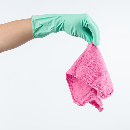 human hand wearing protective glove, holding cleaning cloth, on white backgroundの写真素材
