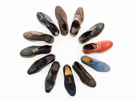 upper view, variety of male shoes arranged in circle, isolated on white background