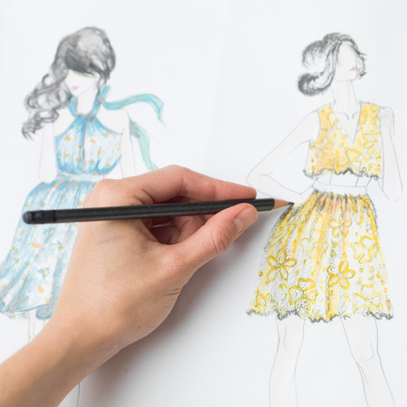 closeup of human hand drawing fashion design on paperの写真素材