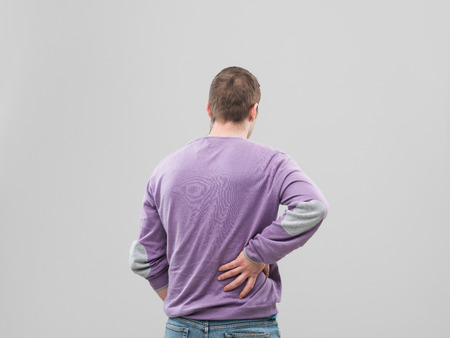 rear view of man having back pain