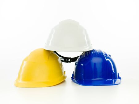 stack of multi colored hardhats isolated on white backgroundの写真素材