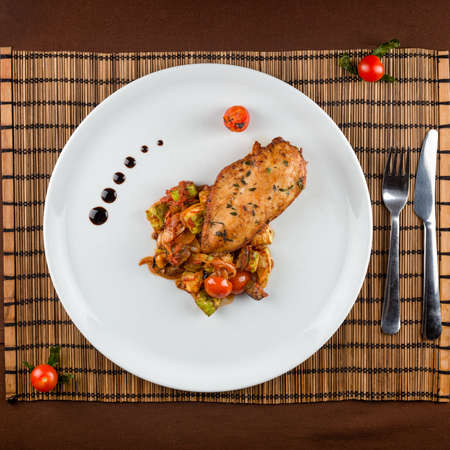 Ratatouille with Baked chicken breast in white dish on the tableの写真素材