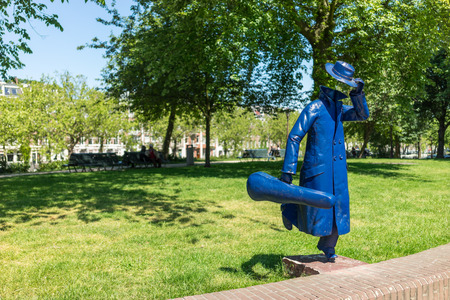 Amsterdam The Netherlands - June 11: 2015 The statue of a running man holding a violin case was the first statue by a mysterious unknown artist that appeared in Amsterdam on June 11, 2015.のeditorial素材