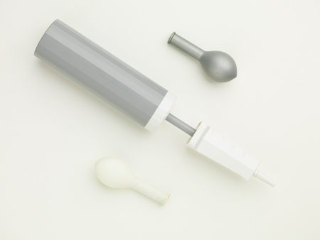 monochromatic balloon pump between two balloons, one white the other grey on a white backgroundの写真素材