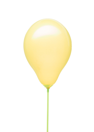 yellow balloon with ribbon flying on isolated on white backgroundの写真素材