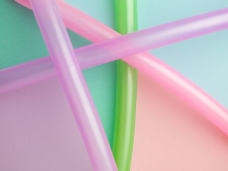 colourful abstract composition of long balloons on shapes of colour paperの写真素材