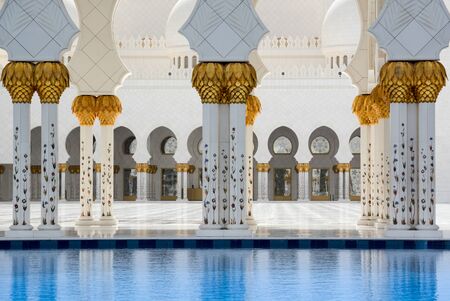 Abu Dhabi, United Arab Emirates - April 12, 2015: Pillars and pool, Sheikh Zayed Grand Mosque in Abu...