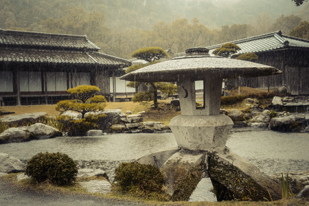 Pagoda statue in a Japanese garden on a rainy dayのeditorial素材
