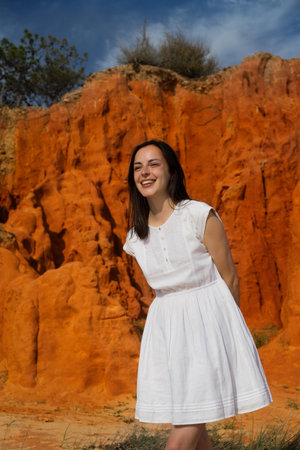 young Woman in white dress, orange background