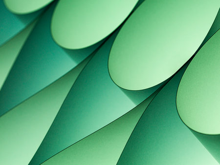 Macro detail of curved paper illuminated with green filterの写真素材