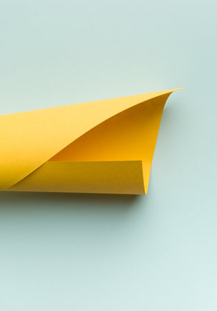 The bright yellow sheet paper on a on lite blue background.の写真素材