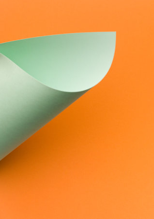 Pastel green paper, curled corner, page curl. Abstract creative background, modern mock up. Design element for advertising and promotional message.の写真素材