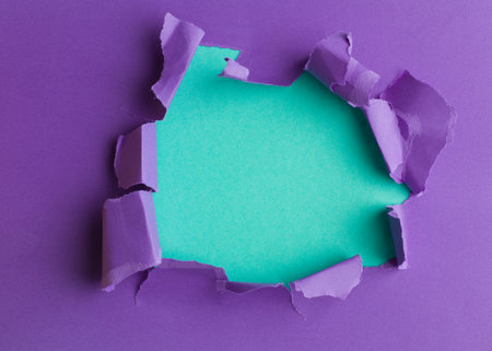 Purple sheet of paper with a round hole  aqua background insideの写真素材