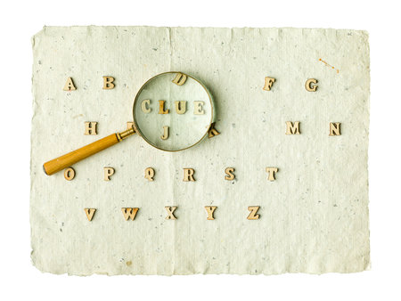 Wooden alphabet blocks with letters. Vintage magnifier on top.の写真素材