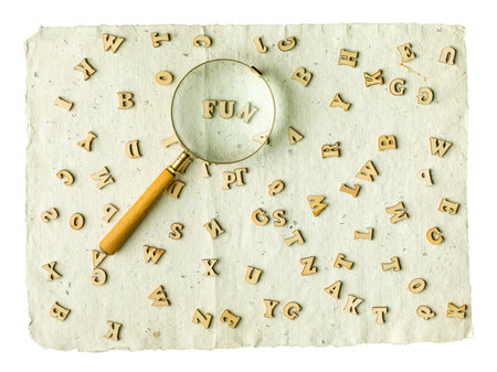Wooden alphabet blocks with letters. Vintage magnifier on top. Fun Games.の写真素材
