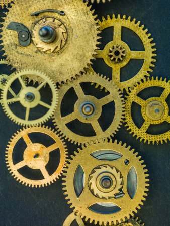 Close view on golden cogs and wheels on blue backgroundの写真素材