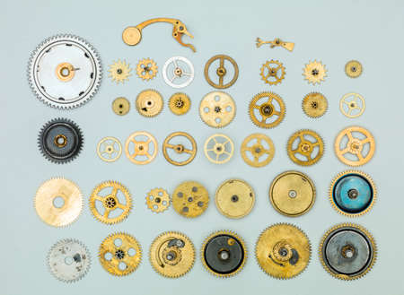 Vintage gears and cogs on light blue background.