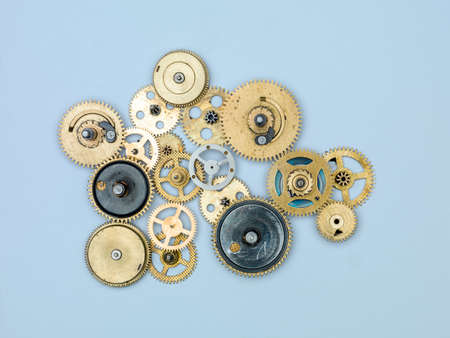 Gears and cogs macro, blue background. Top view. Vintage