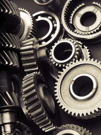 Black industrial gears and cogs on black background