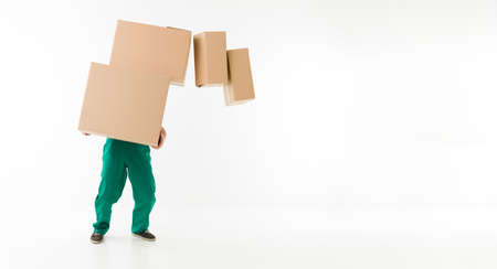 unrecognizable man holding stack of cardboard boxes, dropping some of themの写真素材