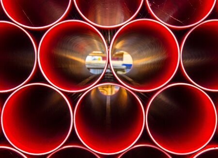 Light shining through Construction pipes all stacked together to create abstract imageの写真素材