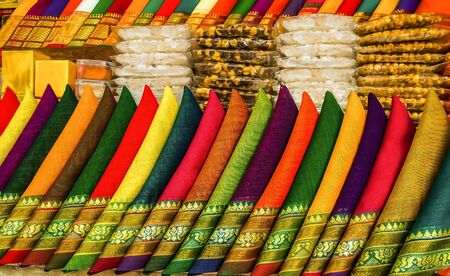 Puja ingredients chickpea bangal gram chana sugar ball varity of red green yellow pink blue color piece of cotton cloths with jari silk border in the shop to be soldの写真素材