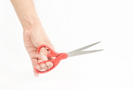 Sewing scissors in hand isolated on whiteの写真素材