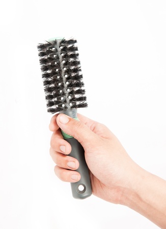 black comb in his hand on a white backgroundの写真素材