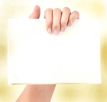 hand holding blank paper isolatedの写真素材