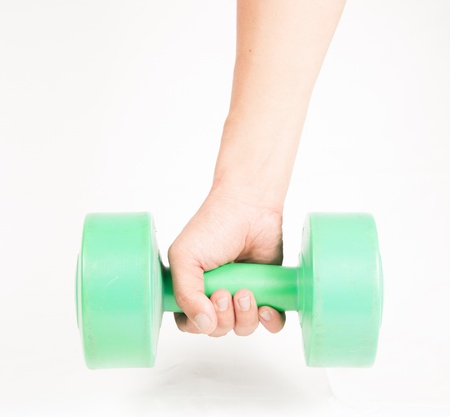 green dumbbell in hand isolated on whiteの写真素材