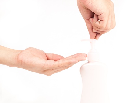 Closeup of beautiful female hands applying hand cream isolatedの写真素材